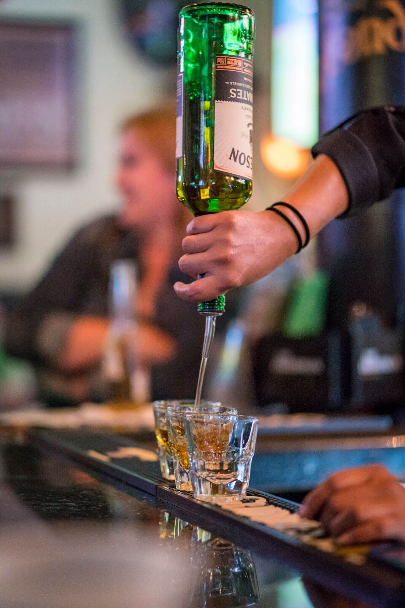 Irish whiskey being poured behind the bar at The Irishman in Huntington Beach